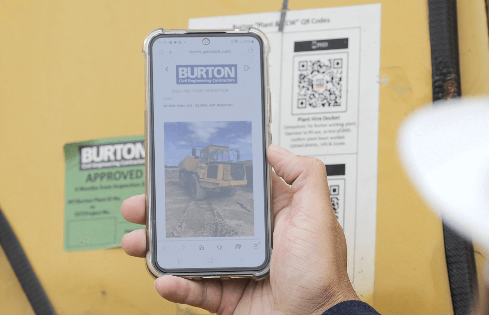 Operator scanning a QR code on a vehicle to open an inspection form in the Sitemate mobile app