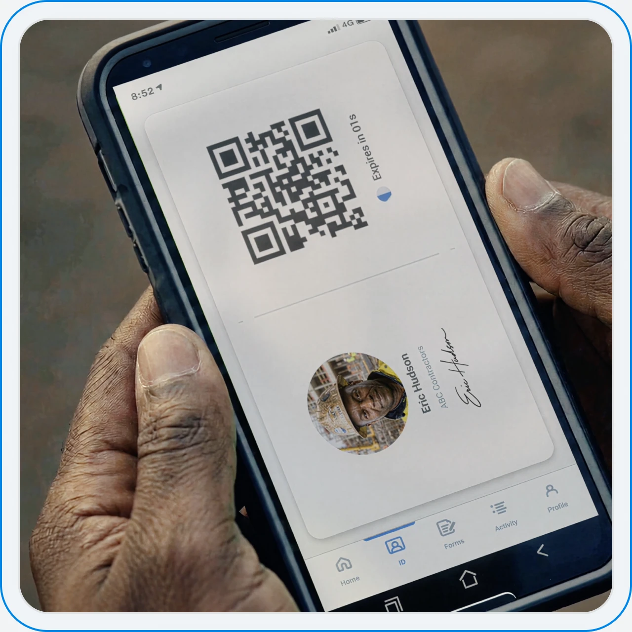 A worker holding a phone showing their Sitemate ID QR code